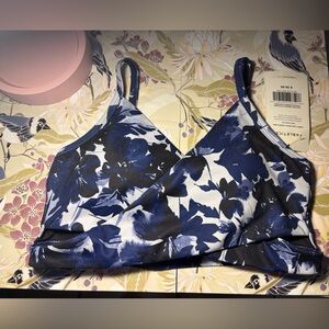Fabletics sports bra with a blue, black, and white floral pattern size small